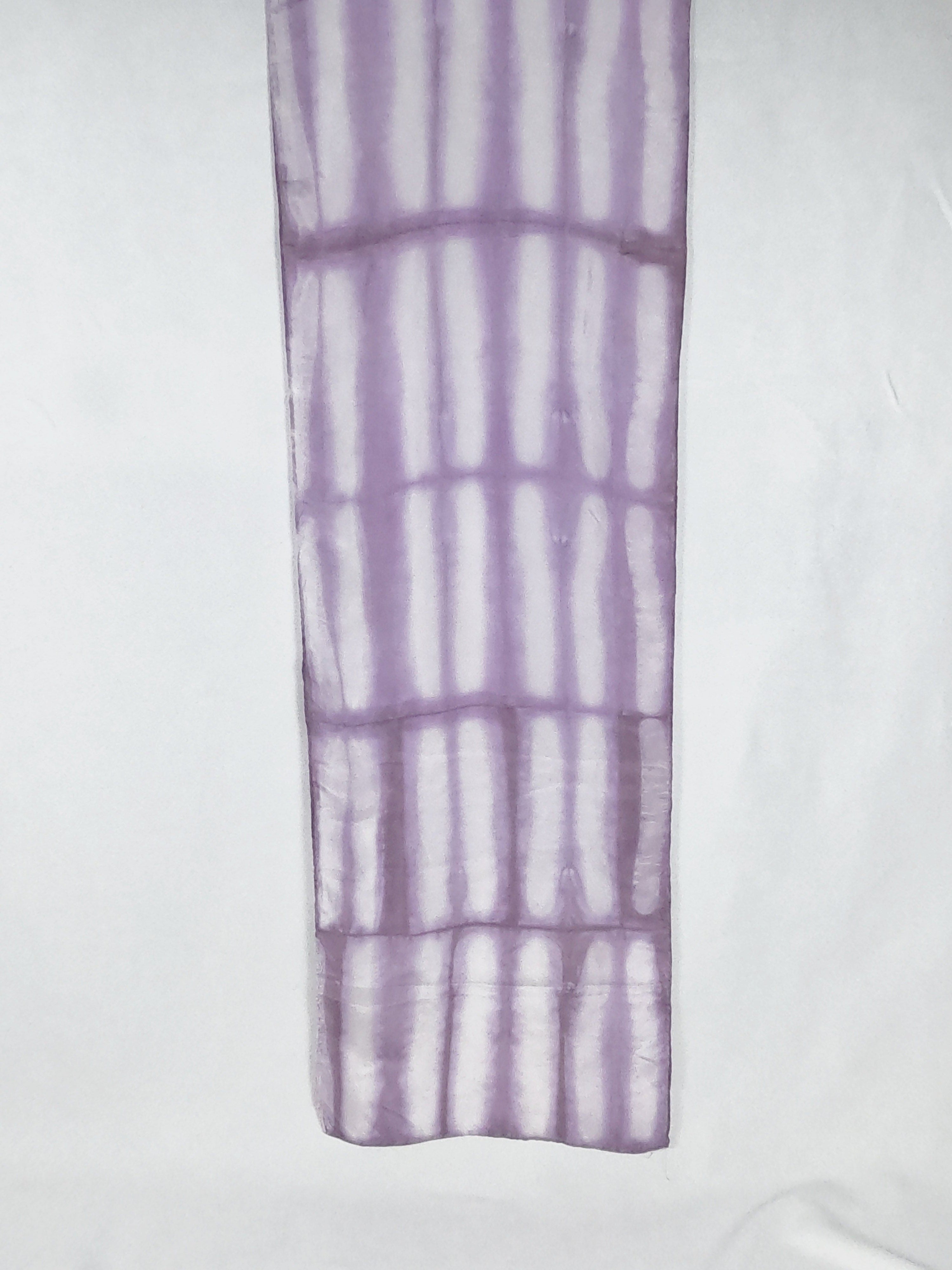 A light lavender coloured scarf laid flat to reveal the full motif. It is long white stripes.